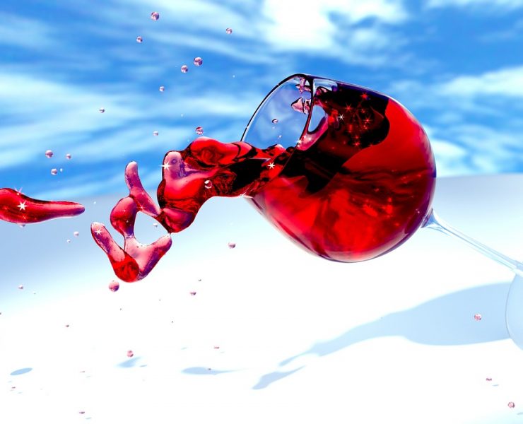 red wine spilling out of a glass conceptual note