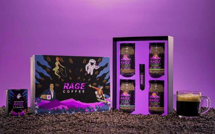 Rage Coffee gift pack with coffee jars, a small box, and a shot tube on a bed of coffee beans. A cup of coffee is on the right. The background is purple with colorful, dynamic graphics.